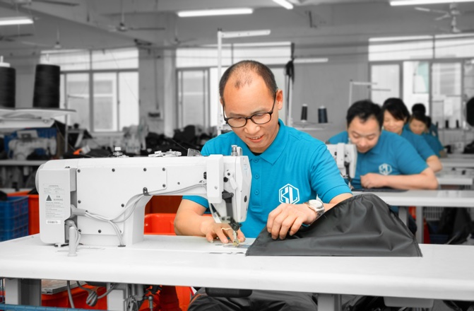 skilled workers manufacture bags efficently by machines