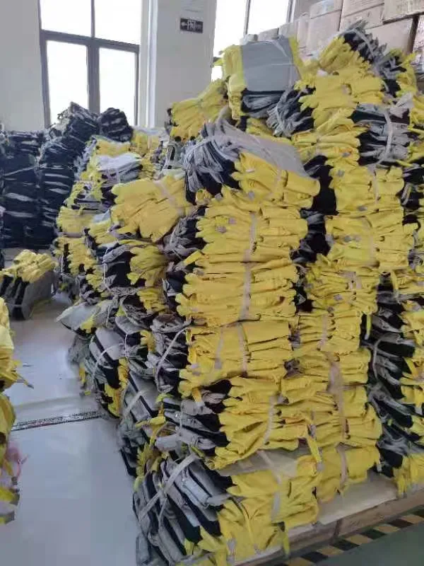 Stacked ready-to-ship yellow and black Bulk Backpacks in a Manufacturer warehouse.