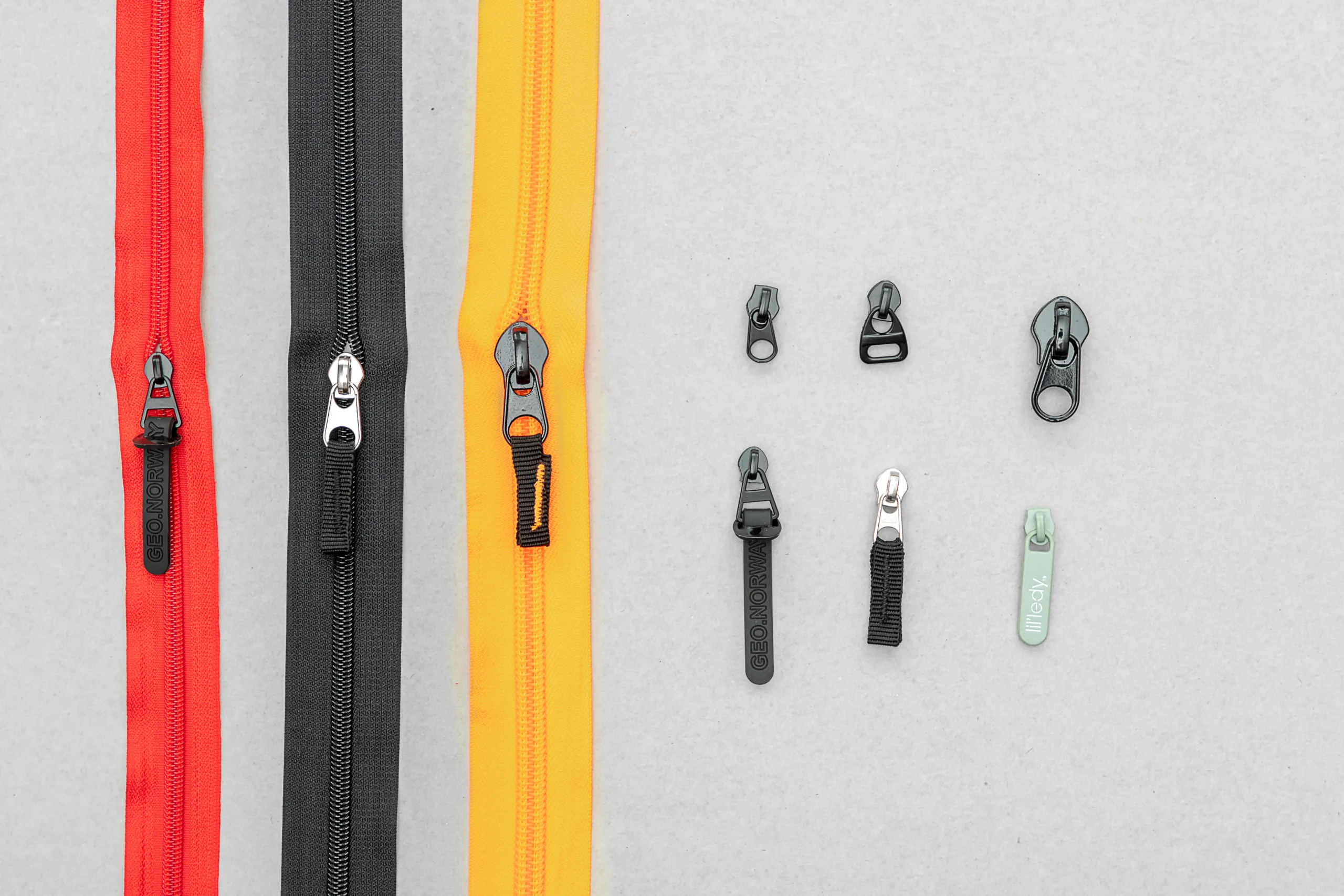 Various colored zipper tapes and zipper pulls. Material hardware selection by a Backpack OEM Supplier.