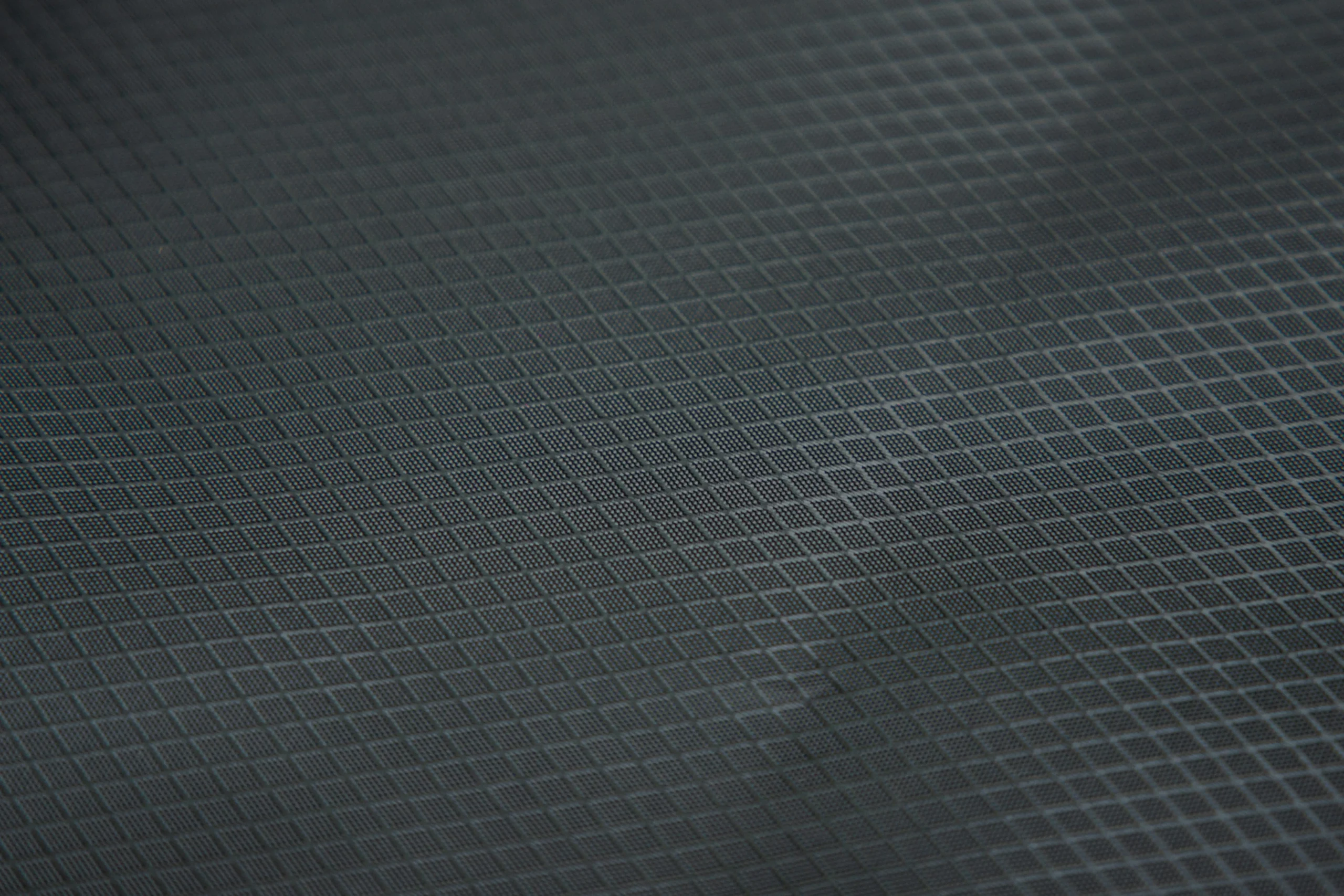 Close up of black ripstop fabric texture. High-quality material used by a Backpack Manufacturer.