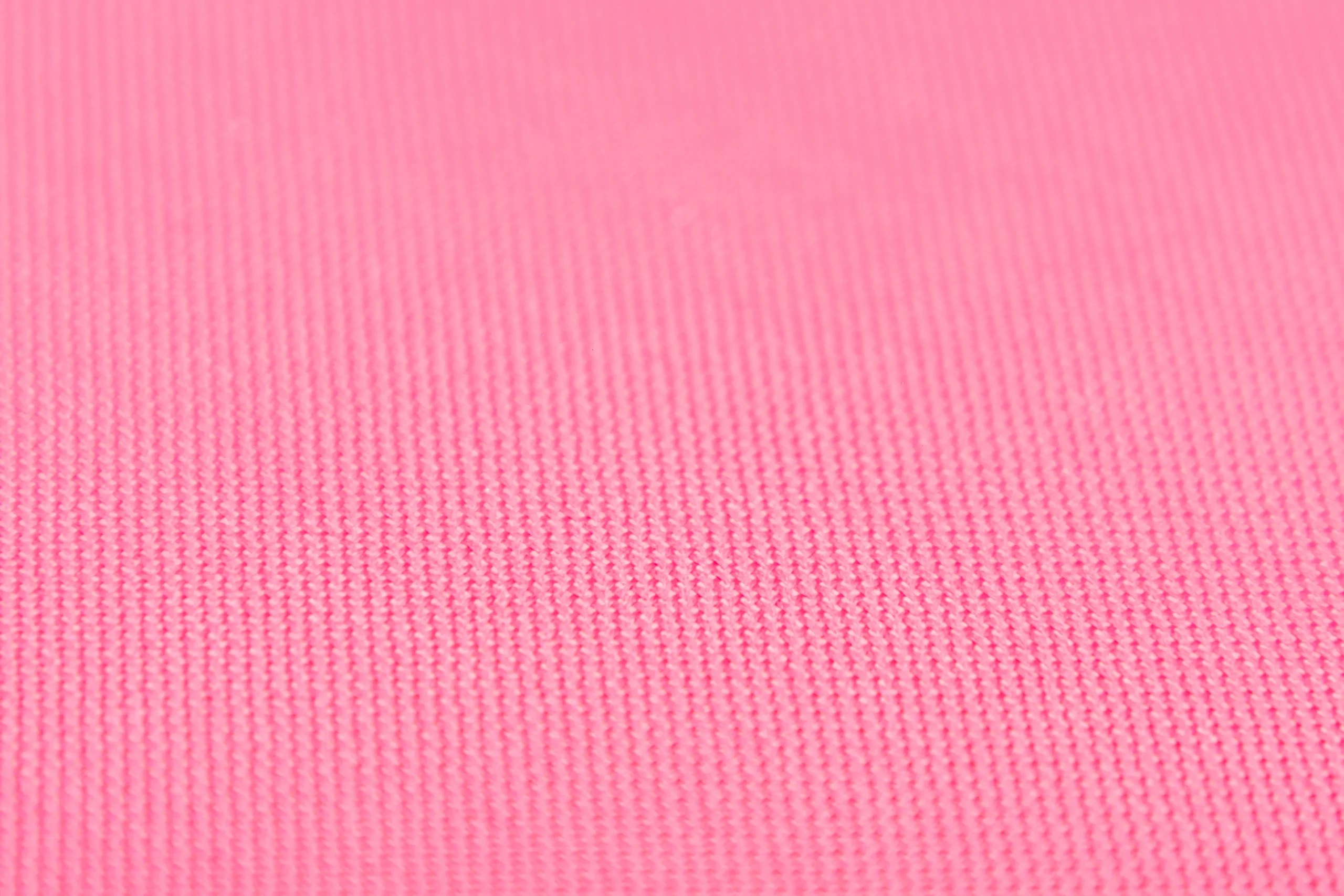 Close up of pink knitted fabric texture. Textile detail from a Backpack Manufacturer.