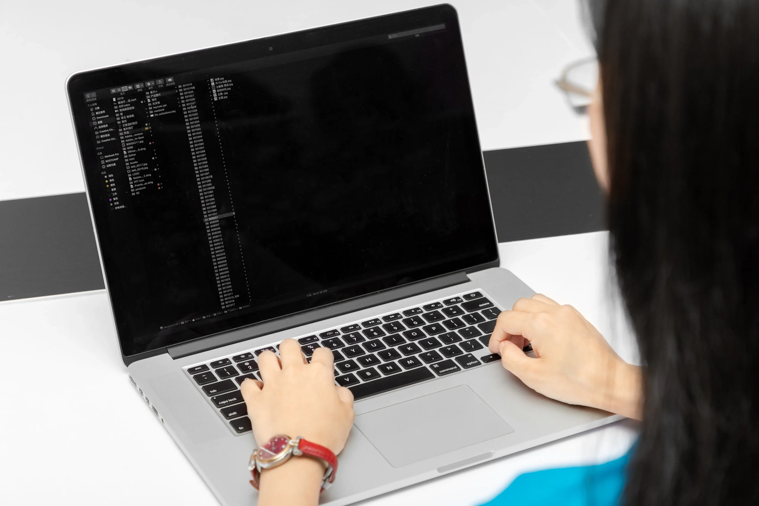 Laptop screen displaying management software or code. Digital backend of a modern Backpack OEM Supplier.