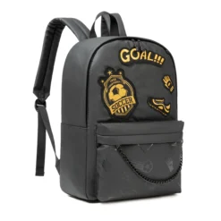 Angled view of a black sports backpack with gold 'GOAL!!!' embroidery and soccer patches. Trendy athletic bag by a Custom Backpack Manufacturer.