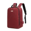 Slanted front view of a minimalist burgundy business backpack with a sleek silver logo plate and a side charging port. Functional smart backpack by a Custom Backpack Manufacturer.