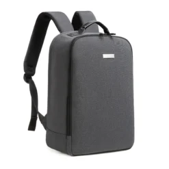 3D angled front view of a dark grey minimalist backpack showing the smooth side zipper and clean lines. Trendy daily commuter bag by a leading Backpack Supplier.