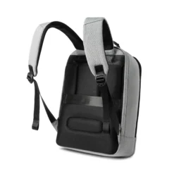 Side-back view of a minimalist light grey business backpack with thick breathable mesh padding and padded shoulder straps. Custom commuter backpack by a professional Backpack Manufacturer.