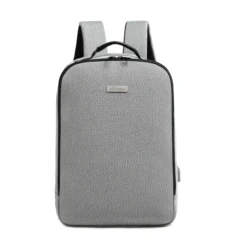 Front view of a minimalist light grey backpack with a rectangular silver logo plate and top grab handle. Professional business bag by a Backpack Manufacturer.