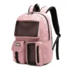 Slanted view of a dusty pink backpack featuring a large front mesh pocket, a buckled flap pocket, and black contrasting zippers. Functional school bag by a Backpack Supplier.