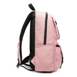 Side profile of a dusty pink backpack showing its structural depth, padded strap, and a safety reflective strip. High-density fabric school bag by a Backpack OEM Supplier.