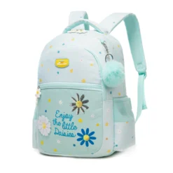 Slanted front view of a mint green daisy backpack featuring a yellow logo patch, embroidered daisies, a blue pom-pom, and floral zipper pulls. Cute school bag by a Backpack Supplier.
