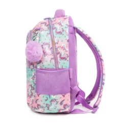 Side profile of a pastel unicorn backpack showing its structural depth, unicorn pattern, and a fluffy purple pom-pom charm. High-density fabric bag by a Backpack OEM Supplier.
