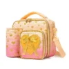 Slanted view of a pastel peach gradient lunch bag with a matching peach detachable bottle holder, heart-shaped zipper pulls, and a 3D bow patch. Functional luxury cooler by a Backpack Supplier.