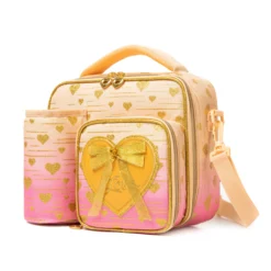 Slanted view of a pastel peach gradient lunch bag with a matching peach detachable bottle holder, heart-shaped zipper pulls, and a 3D bow patch. Functional luxury cooler by a Backpack Supplier.