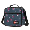 3D angled view of a denim blue floral lunch bag showing the black structural piping and front pocket. Trendy daily cooler by a leading Backpack Supplier.