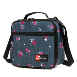 3D angled view of a denim blue floral lunch bag showing the black structural piping and front pocket. Trendy daily cooler by a leading Backpack Supplier.
