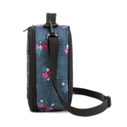 Side profile of a denim blue floral lunch bag showing its depth and adjustable black shoulder strap. High-density fabric bag by a Backpack OEM Supplier.