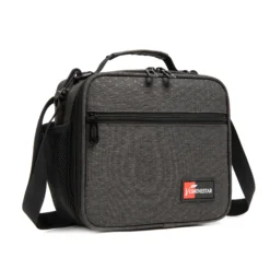 Slanted view of a dark gray geometric lunch bag featuring a front zipper pocket and a red branded logo patch. Functional cooler bag by a Backpack Supplier.