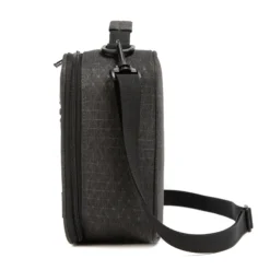 Side profile of a dark grey ripstop lunch bag showing its depth and adjustable black shoulder strap. High-density fabric bag by a Backpack OEM Supplier.