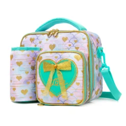 Slanted view of a mermaid-scale lunch bag with a matching detachable bottle holder, heart-shaped zipper pulls, and a 3D green bow patch. Functional luxury cooler by a Backpack Supplier.