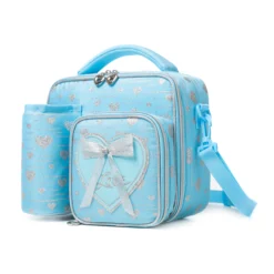 Slanted view of a sky blue glitter heart lunch bag with a matching detachable water bottle holder, heart-shaped zipper pulls, and a 3D bow patch. Functional luxury cooler by a Backpack Supplier.