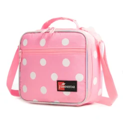Slanted view of a pastel pink polka dot lunch bag with a front zipper pocket, a red logo patch, and reflective trim. Functional sweet cooler by a Backpack Supplier.