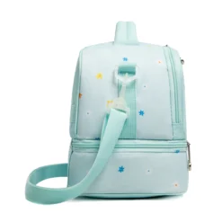 Side profile of a mint green daisy double-decker lunch bag showing its structural depth, delicate star pattern, and an adjustable strap. High-density fabric bag by a Backpack OEM Supplier.