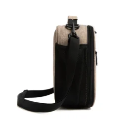 Side view of an oatmeal lunch bag showing a large black mesh water bottle pocket and a sturdy strap swivel clip. Functional daily cooler by a Backpack Manufacturer.