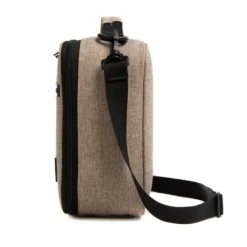 Side profile of an oatmeal heather lunch bag showing its depth and adjustable black shoulder strap. High-density fabric bag by a Backpack OEM Supplier.