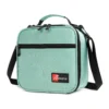 Slanted view of a mint green textured lunch bag with a front zipper pocket and a red logo patch. Functional commuter cooler by a Backpack Supplier.